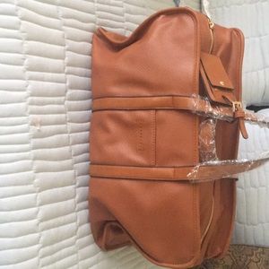 Tan Sole Society weekender tote.